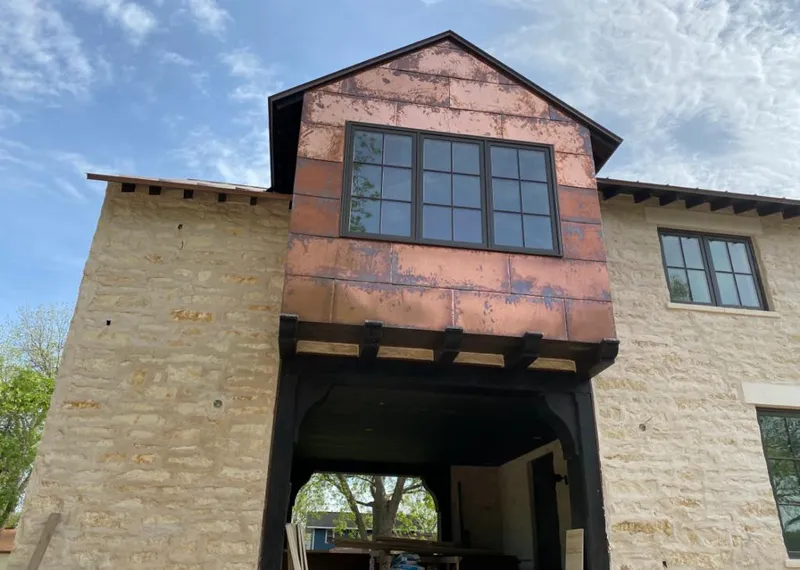 Copper metal panel facade on a stone building for Metal Roof Coating in Edgewood