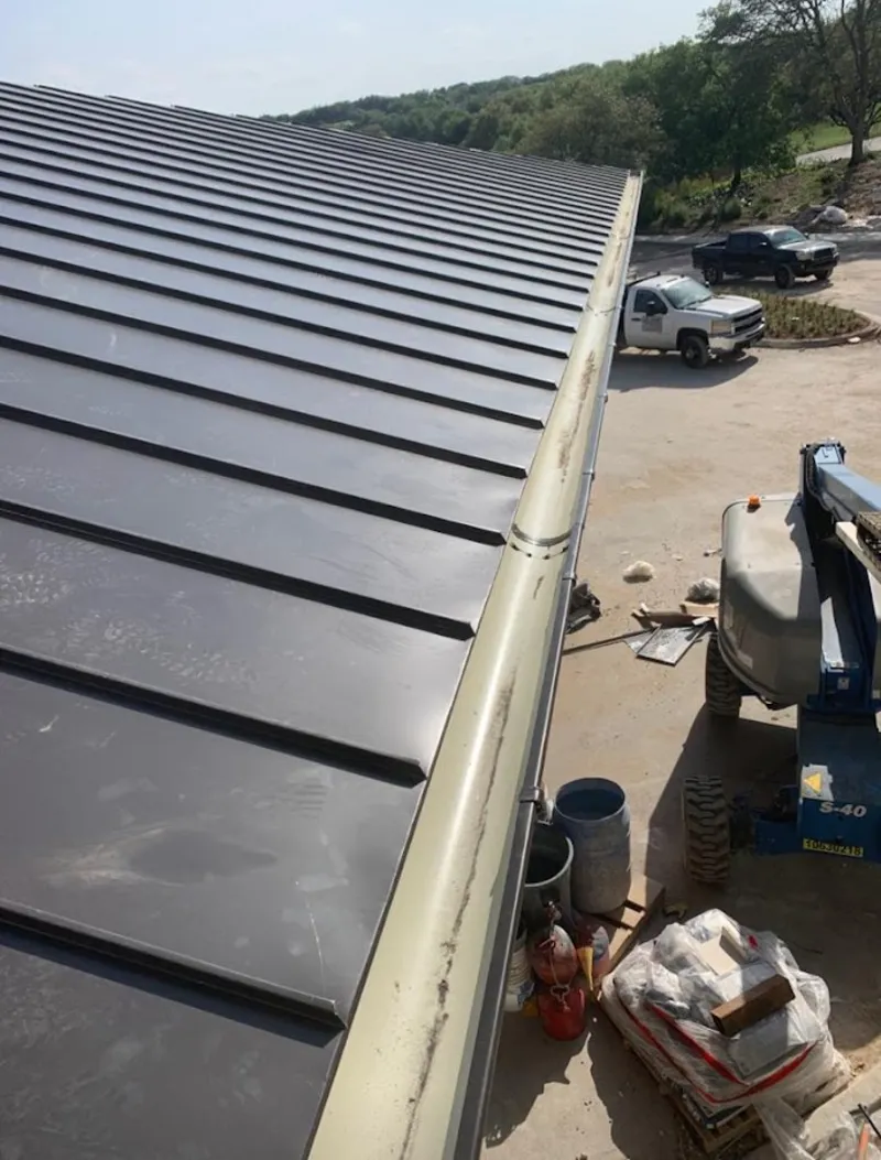 Standing seam panel and gutter detail on a metal roofing jobsite in Edgewood